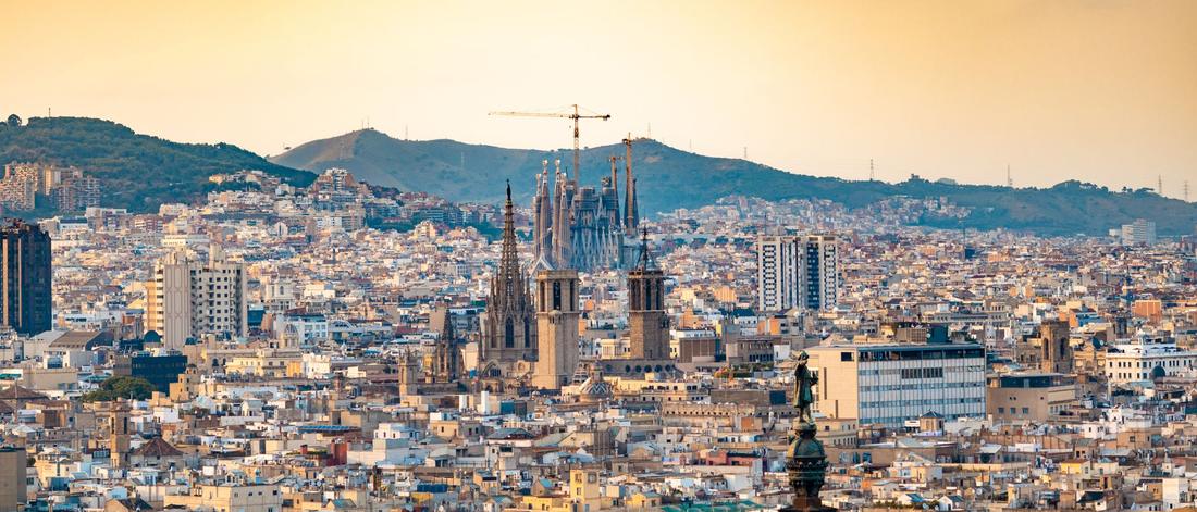 A breathtaking aerial view of Barcelona featuring the iconic Sagrada Familia at sunset.