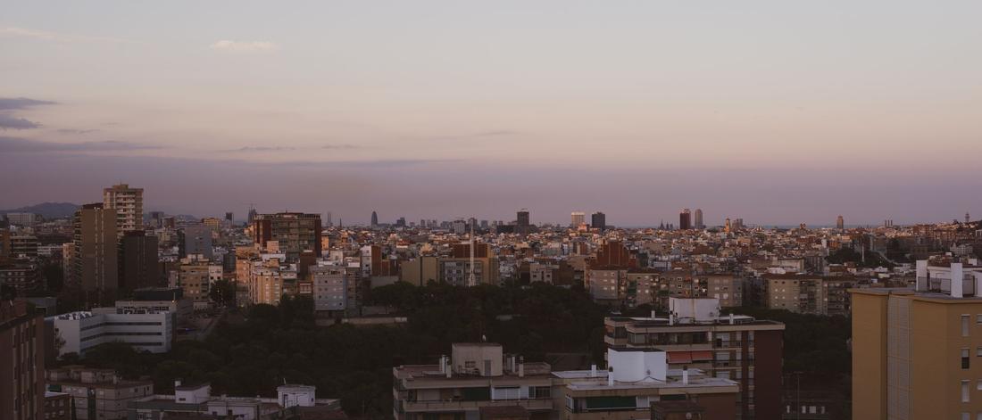 A stunning overview of Barcelona's architecture as twilight sets in, showcasing urban density and skyline.